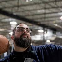 An alumnus about to throw a football at the Fowling Fun Event